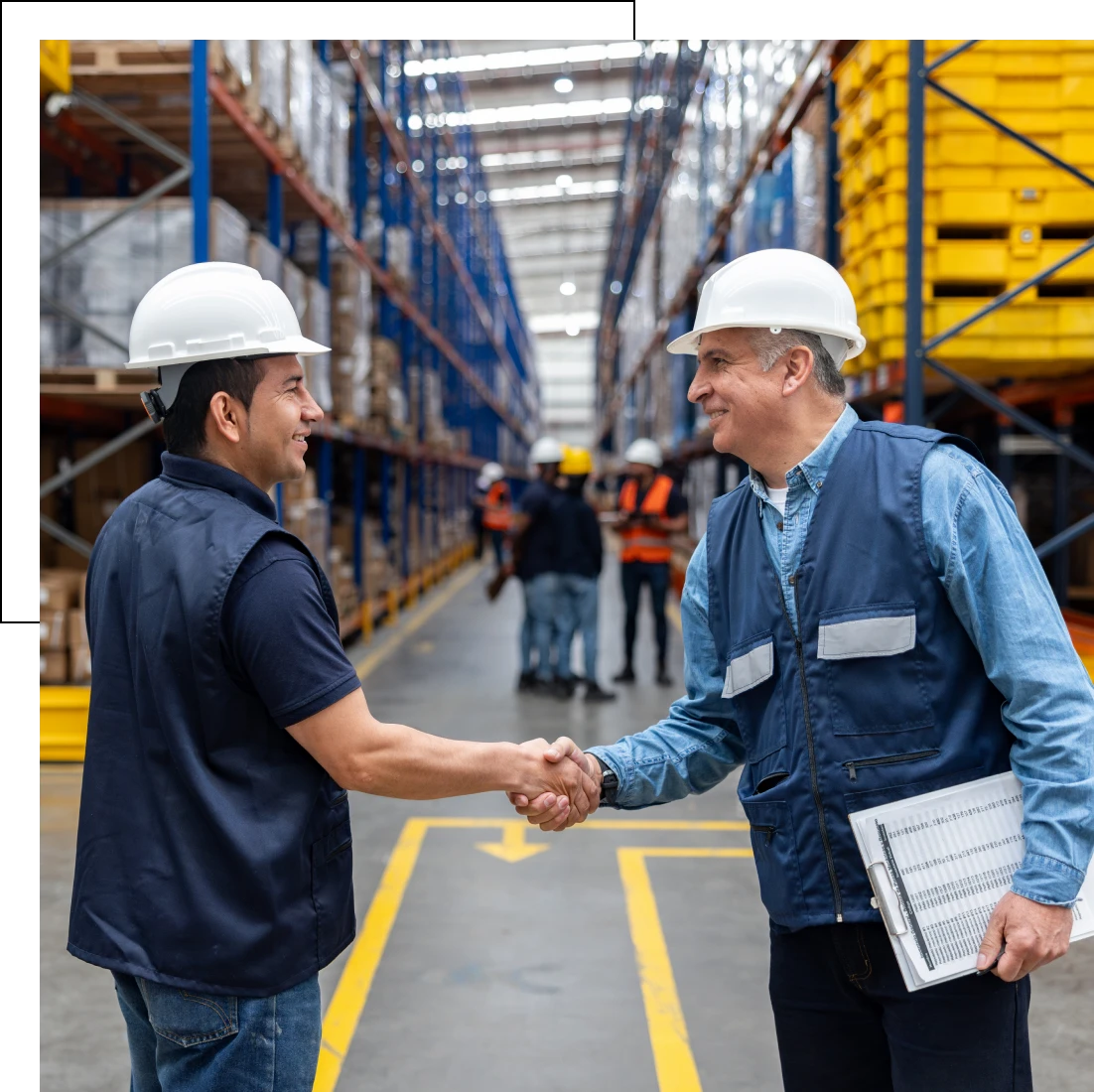 Two men greeting in industrial setting